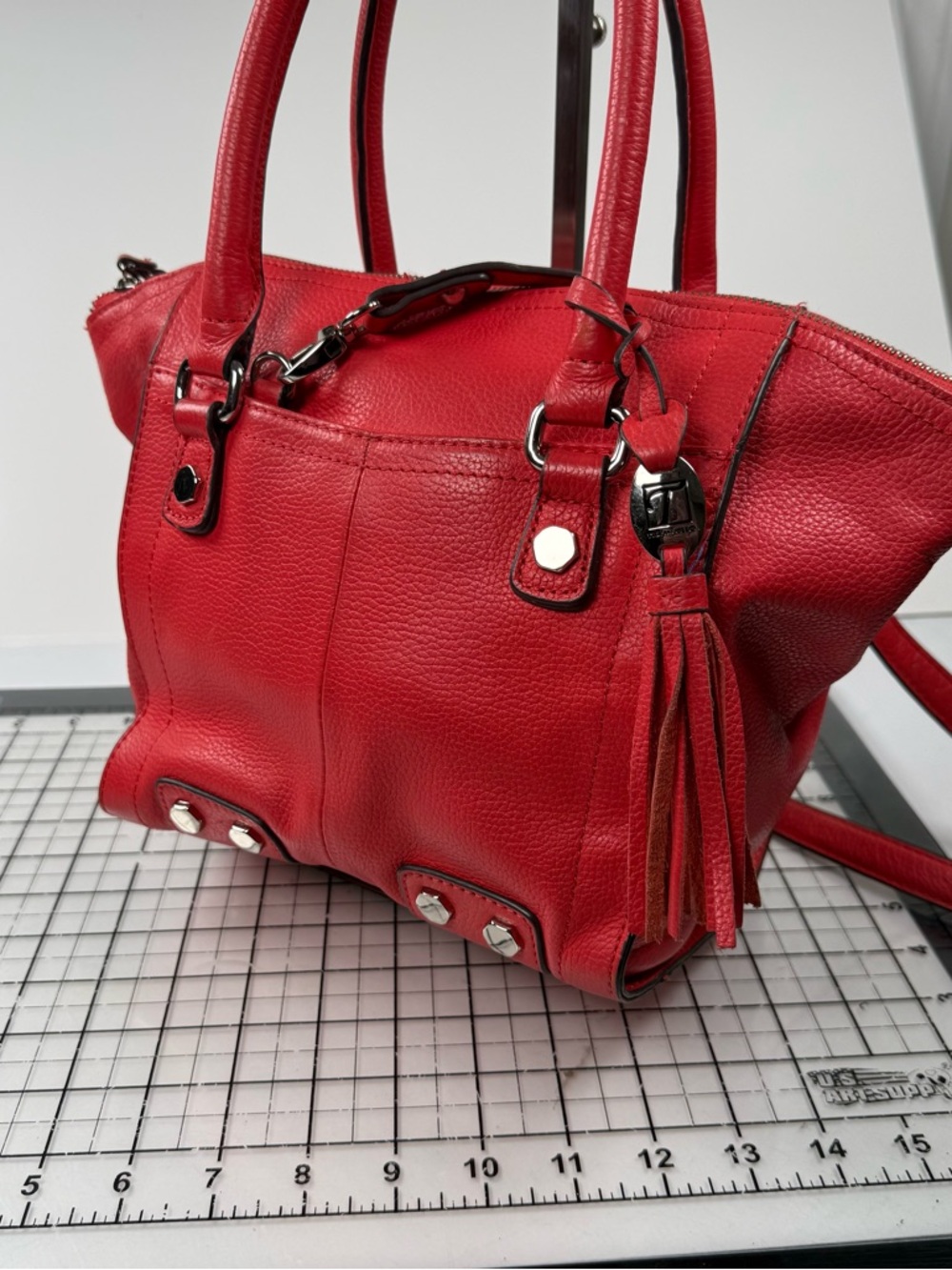 Tignanello Red Orange  Leather Tassel Tote Handbag. Metal accents.
